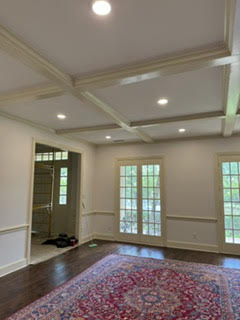 Finished coffered ceiling living room with refinished floors
